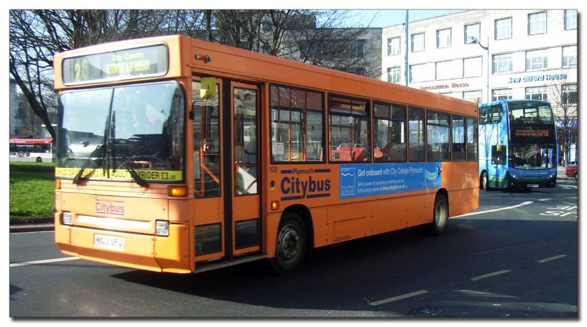 a passenger bus is driving on the road