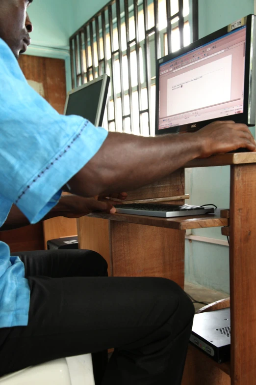 person with a hand on a computer monitor