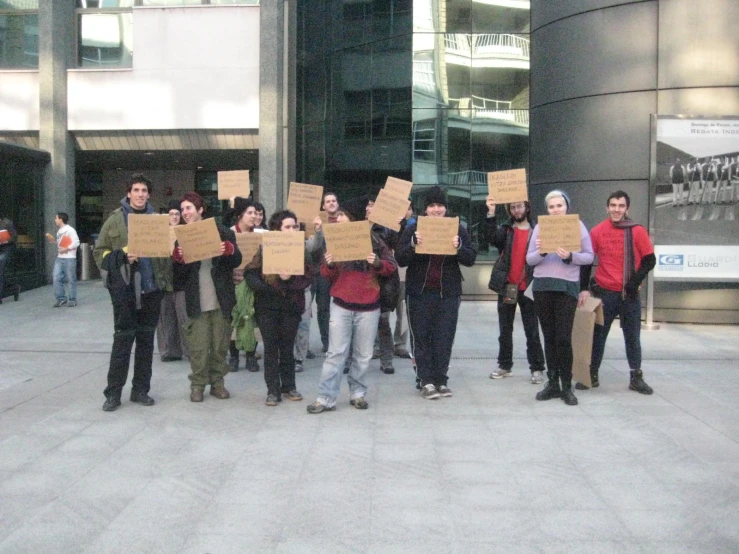 a group of people with signs near buildings