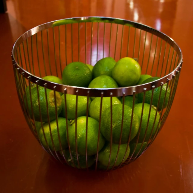 a glass bowl that is filled with limes