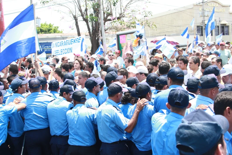 people standing in the street with blue uniforms on