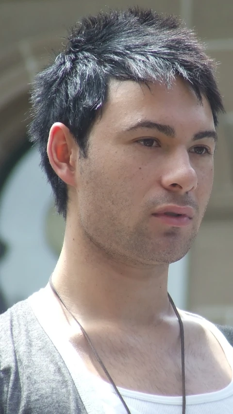 young man looks intently at soing while he talks