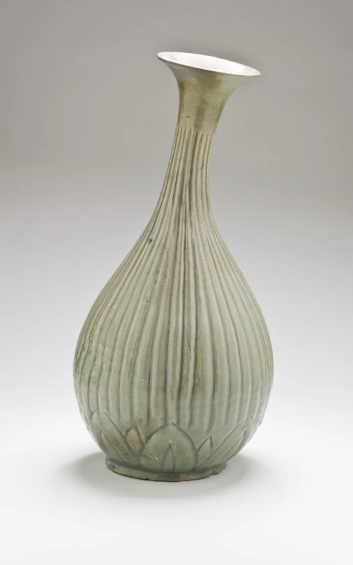 a vase with wavy designs on it in front of a gray background