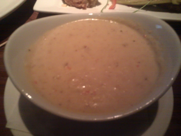 a bowl filled with food next to a plate