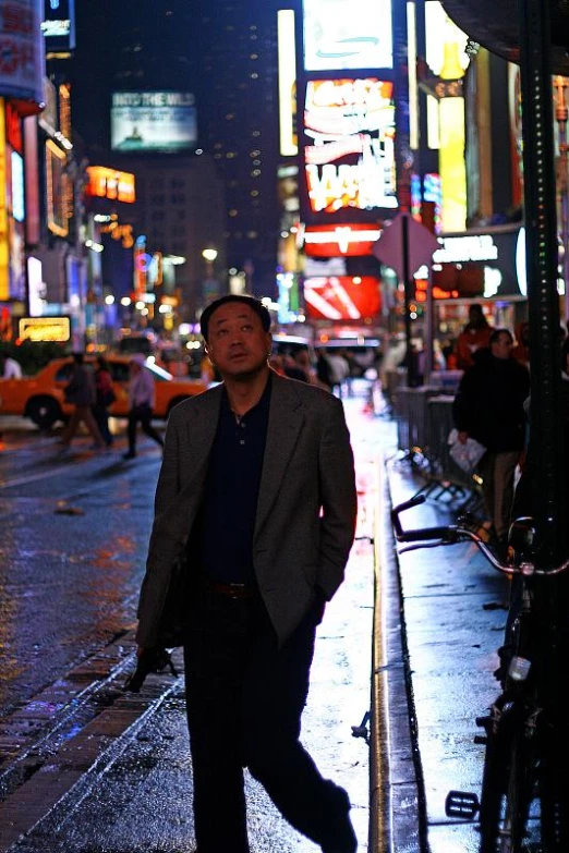 man in city at night walking down the street