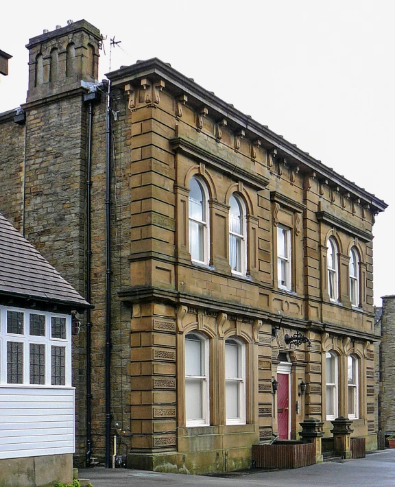 the old building has several windows and white doors