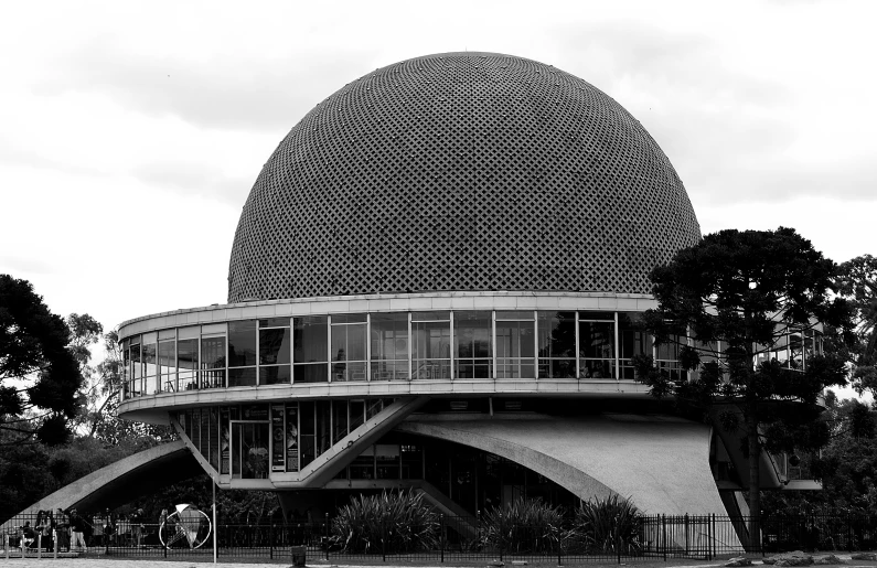 a large structure sitting on top of a hillside surrounded by trees