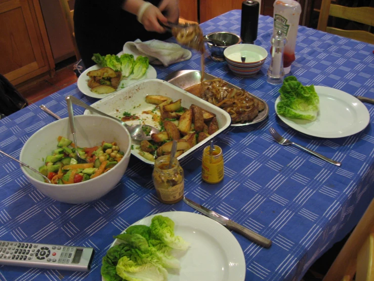 there is food sitting on the table with a blue table cloth