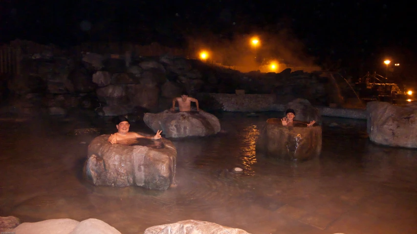 a  spring filled with rocks sitting in the middle of a lake