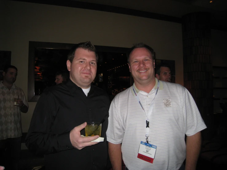 two men pose for the camera in the dark