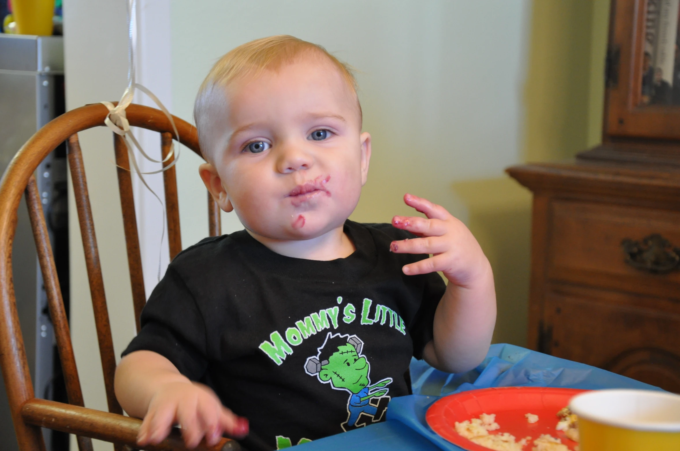 a  at the table eating and taking a bite out of his fork