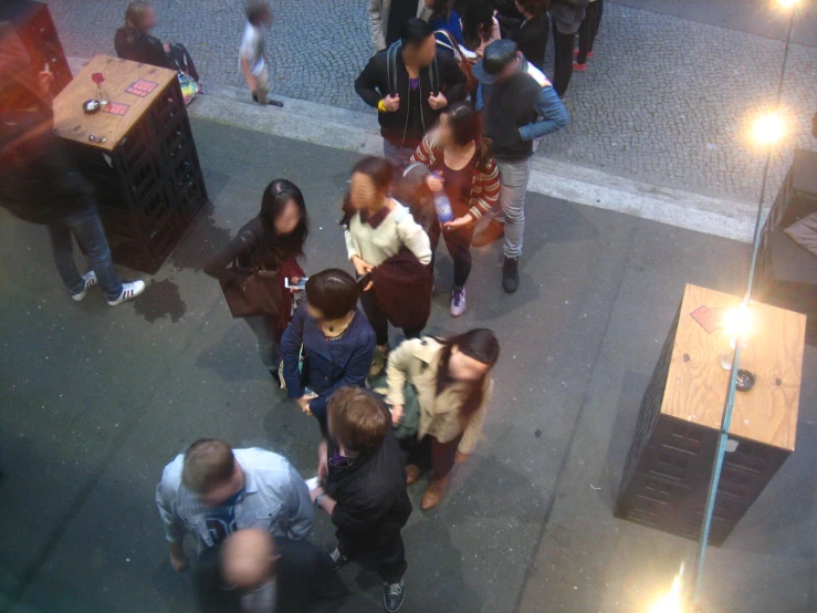 a crowd is gathered around tables and benches