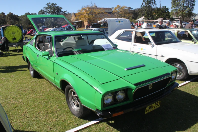 a bright green car at a car show