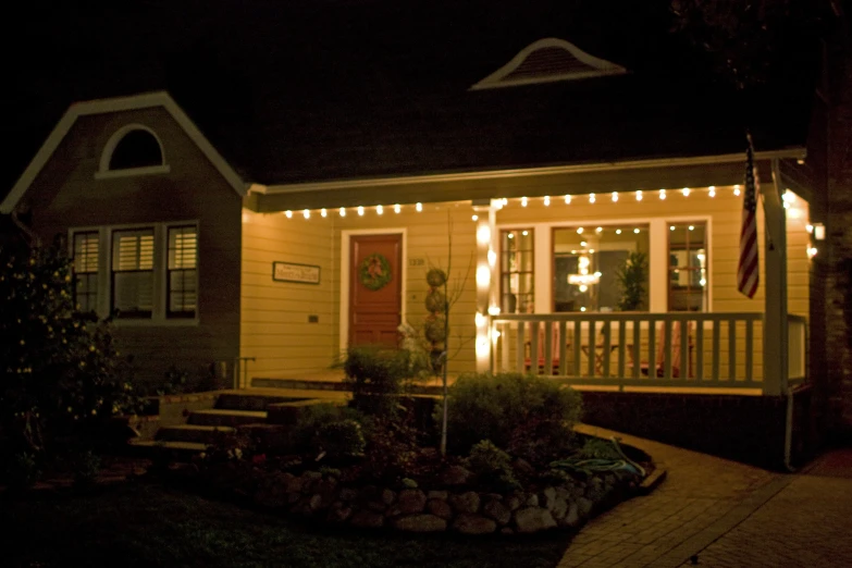 a little house covered in christmas lights at night