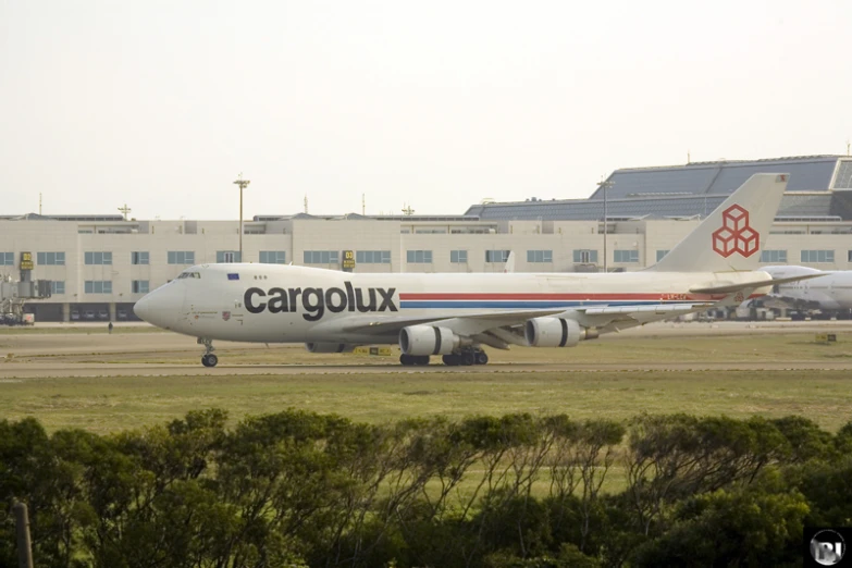 cargo plane sitting on an airport runway near buildings