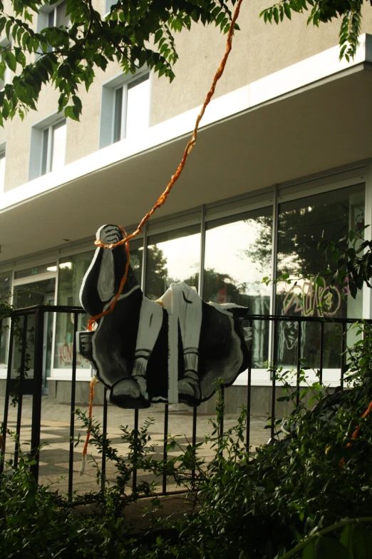 a sculpture of a dog is on display outside of a building