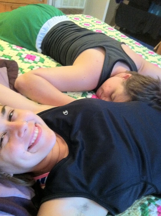 two people laying down together on a bed