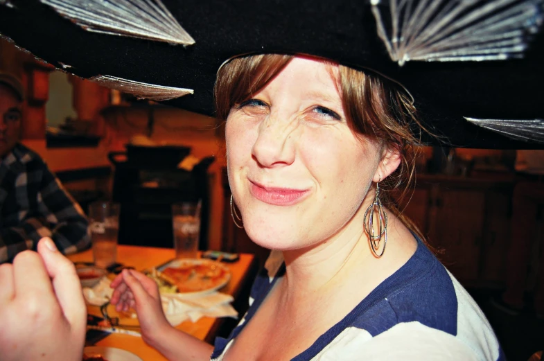 a woman is dressed up in a pirate hat