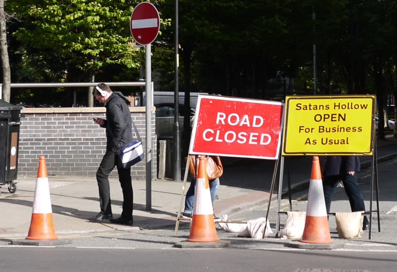 several traffic cones with one on the road closed