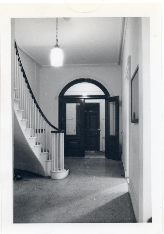 a stair and a hallway with black doors