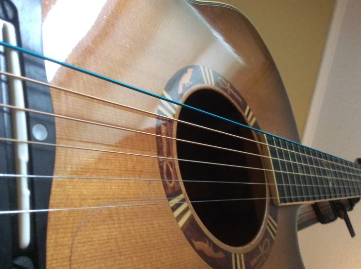 a guitar with a shiny wood back and sides