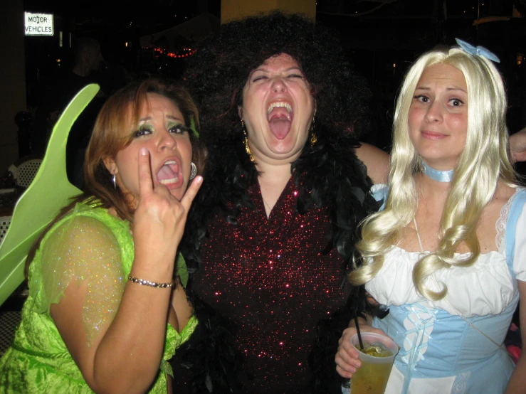 three woman are posing for a picture together