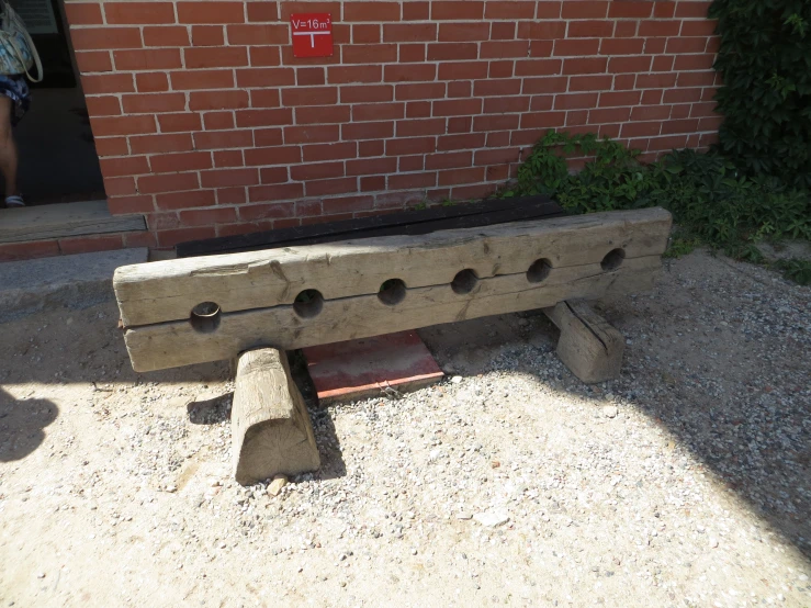 a bench made of concrete sits in the sand