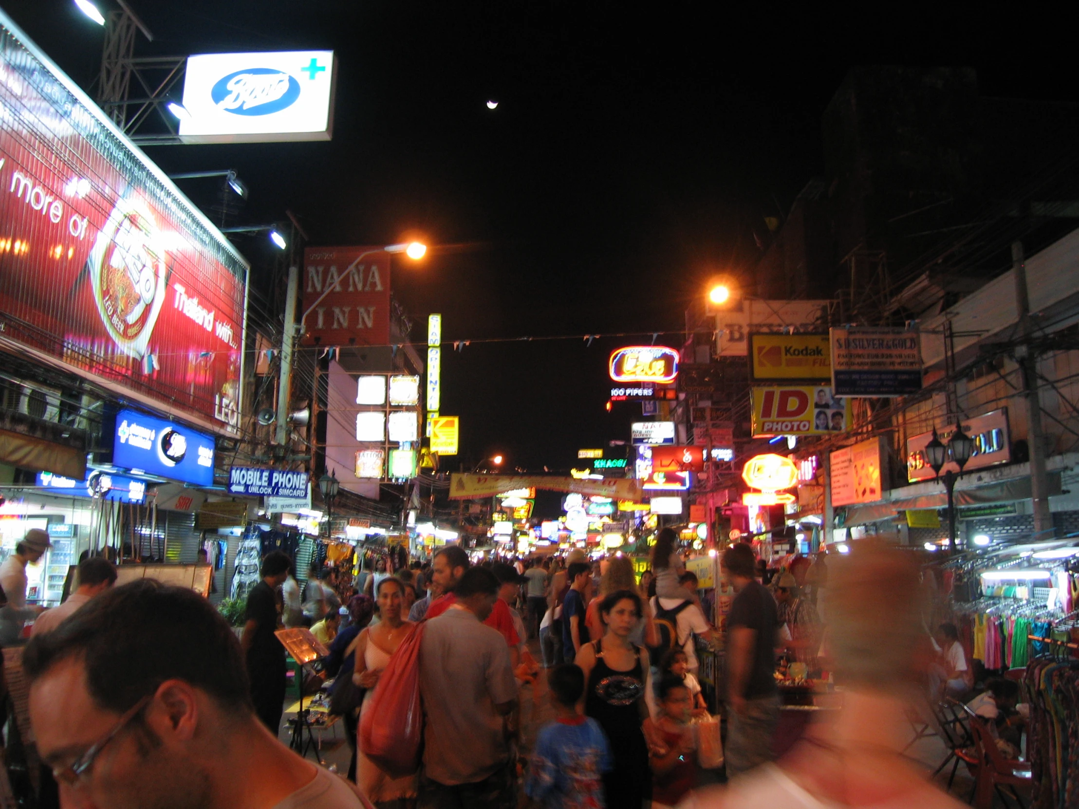 large group of people walking down an urban street