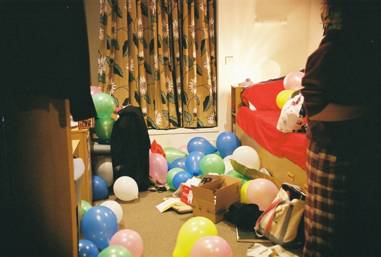 an assortment of balloons are scattered around the room
