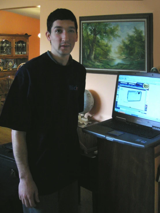a man standing in front of a lap top computer