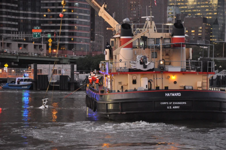 a large tug boat is being hed down the river