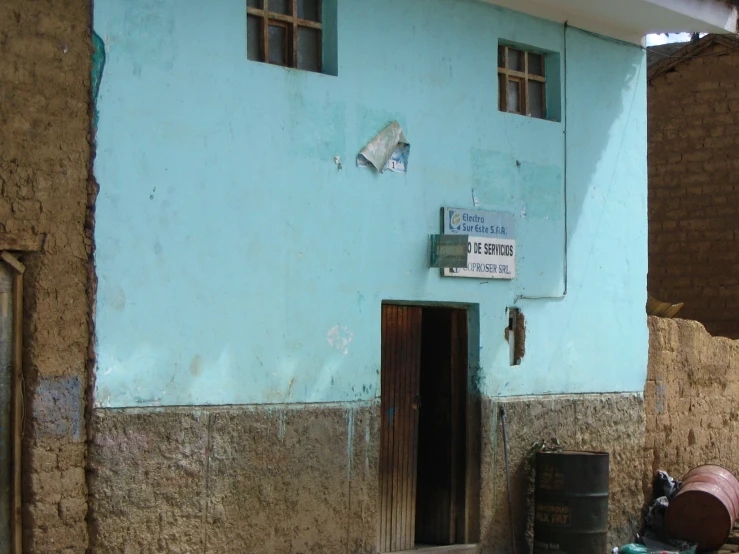 a blue building with many windows has a sign over it