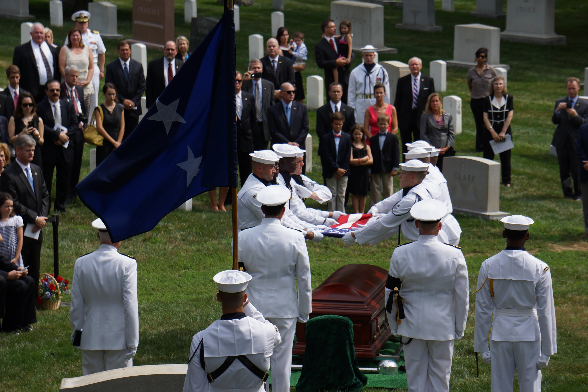 men in military uniforms shaking hands over the body of an officer