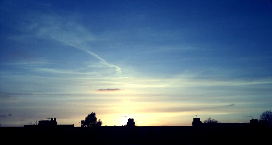 the silhouette of the city buildings is shown at sunset