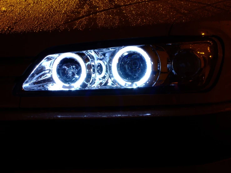 an image of a car head light with blue lights