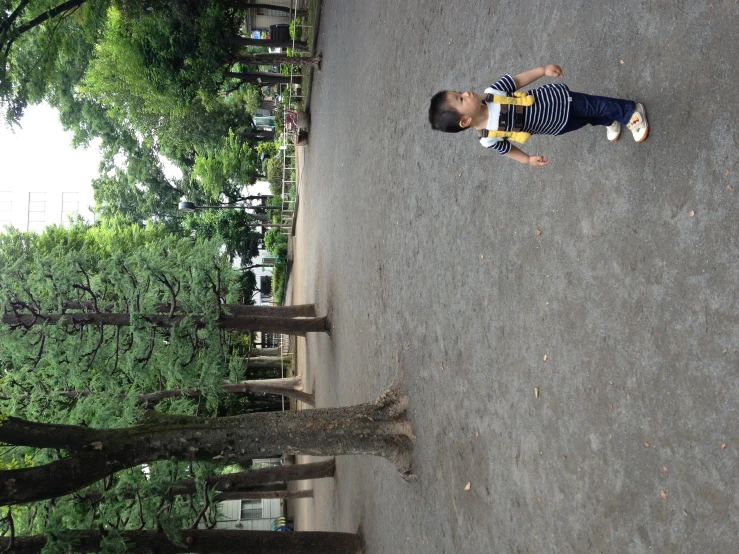 a boy playing with a frisbee in the park