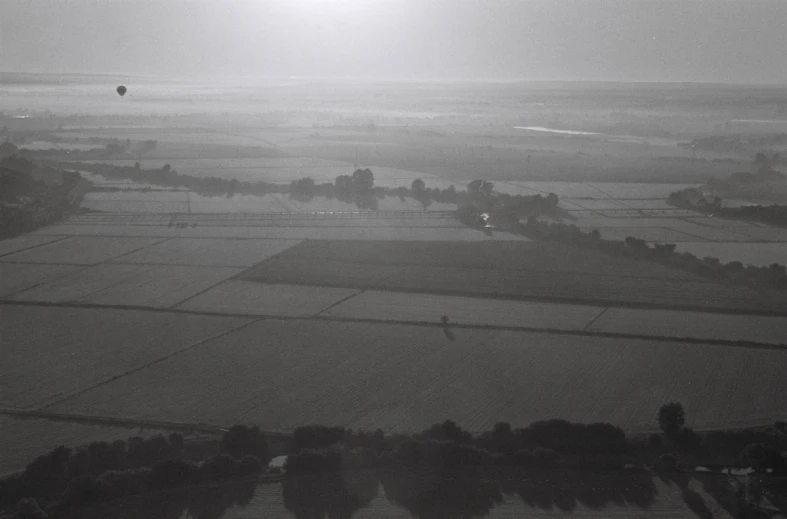 an aerial view of farmlands and a  air balloon