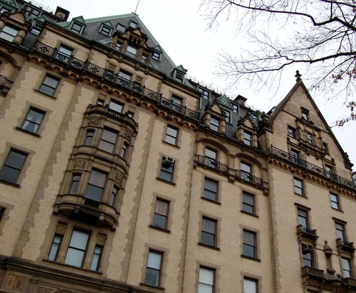 a large tan building with many windows on top