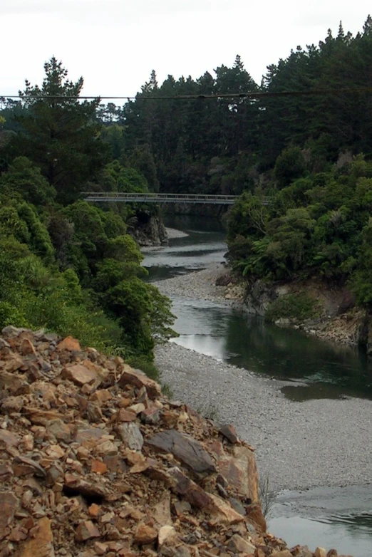 a view of the rocks and trees next to a river