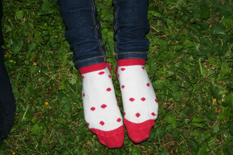 a woman's legs are visible from the bottom up on the grass