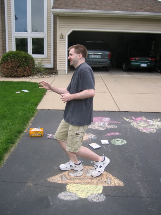 a man walking down the sidewalk and throwing some confetti