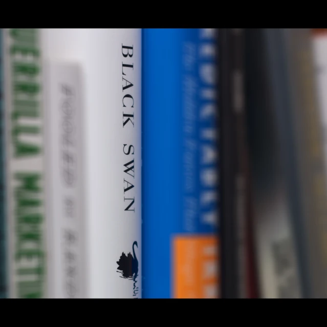 the book shelf has a row of books on it