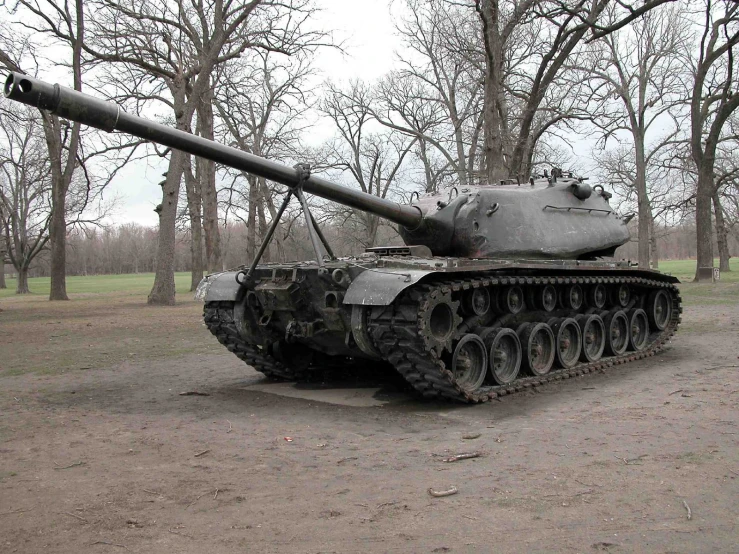 an old tank sitting in the middle of a field