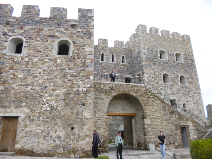 a castle with several doors and a brick wall