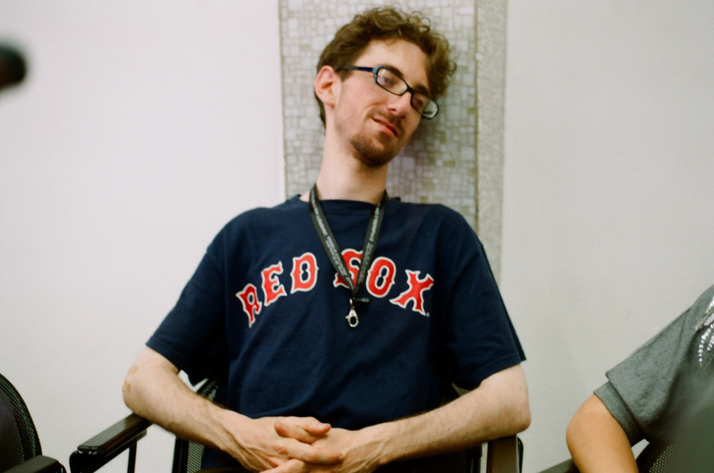 a man sitting in a chair with his hands folded