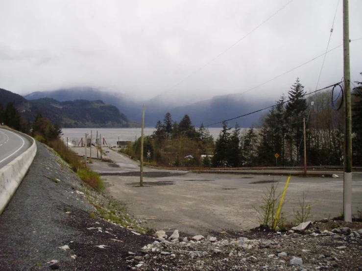 a road going over an empty intersection with mountain in the background