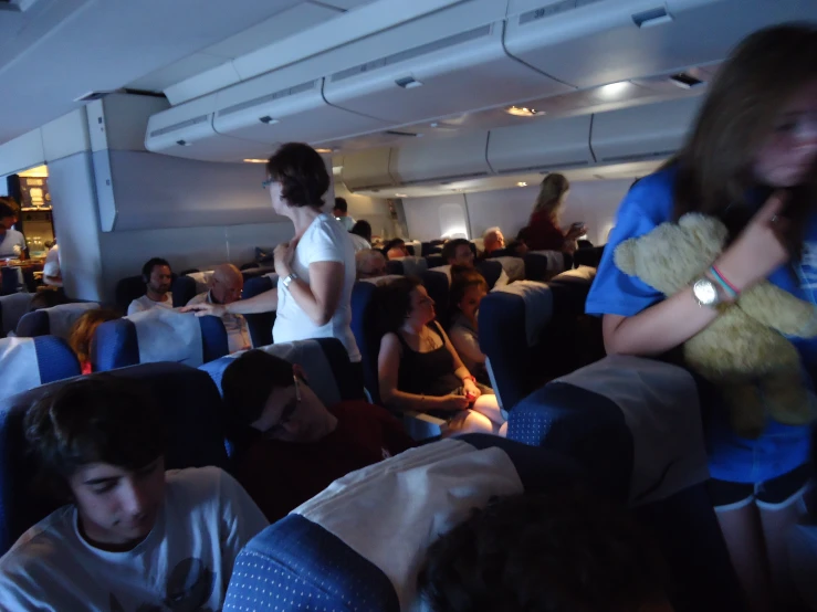 a bunch of people sitting on and around inside of a plane