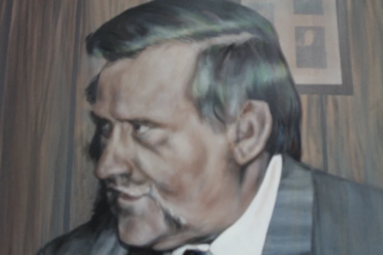 a man with a mustache, wearing a suit and tie