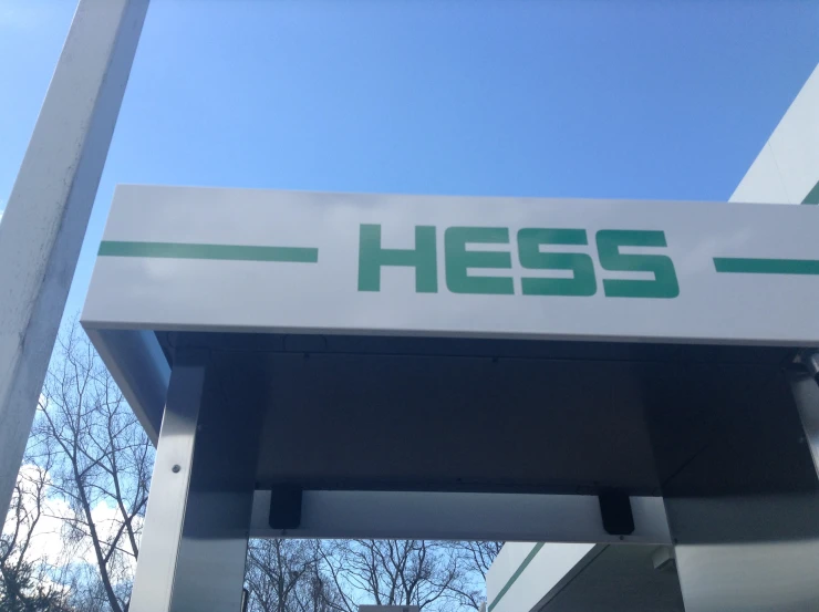 a gas station sign against a blue sky