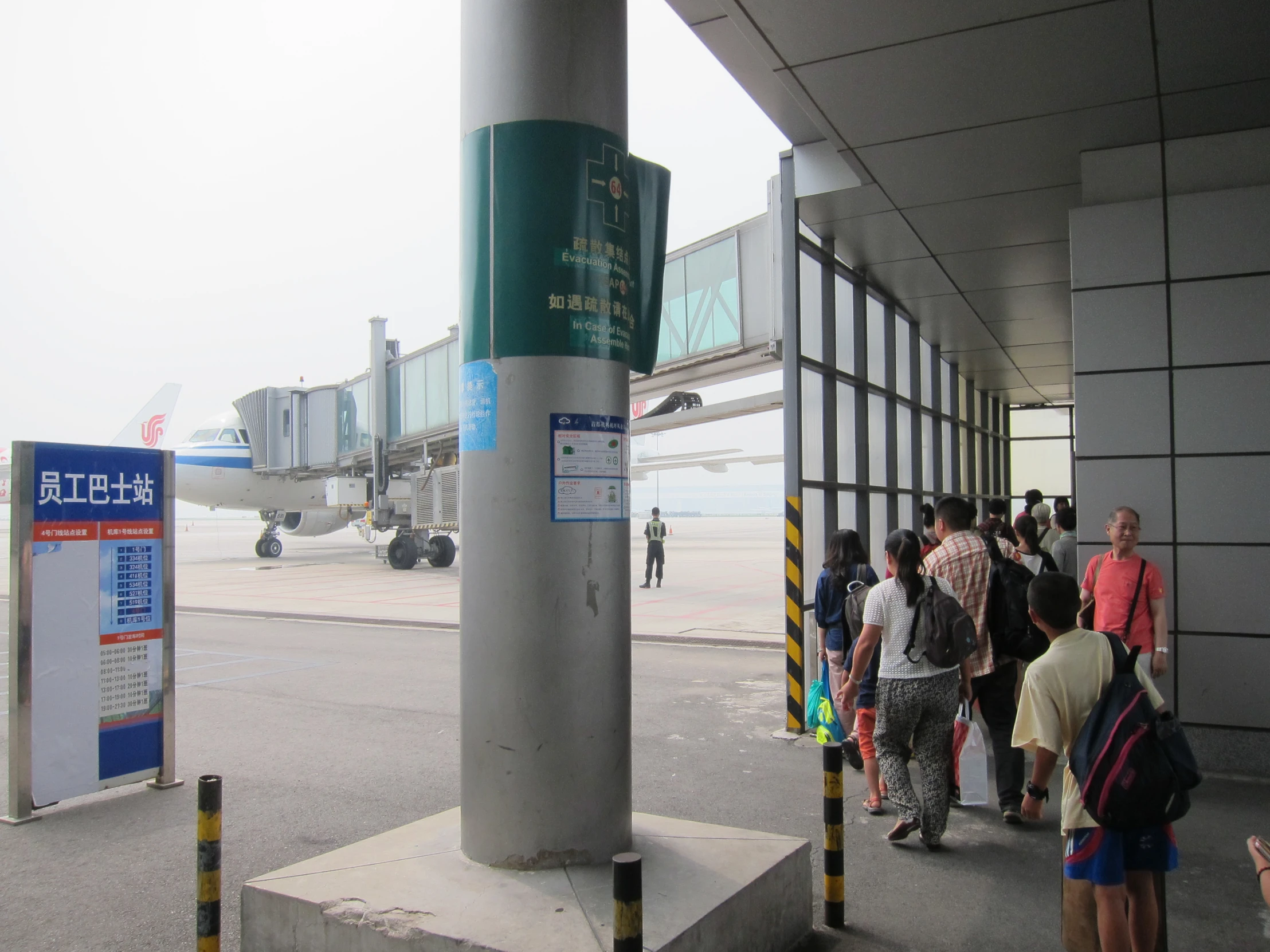 a group of people walking around at an airport